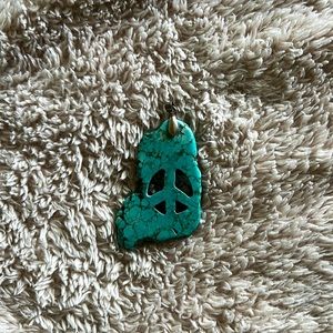 Turquoise peace sign pendant.